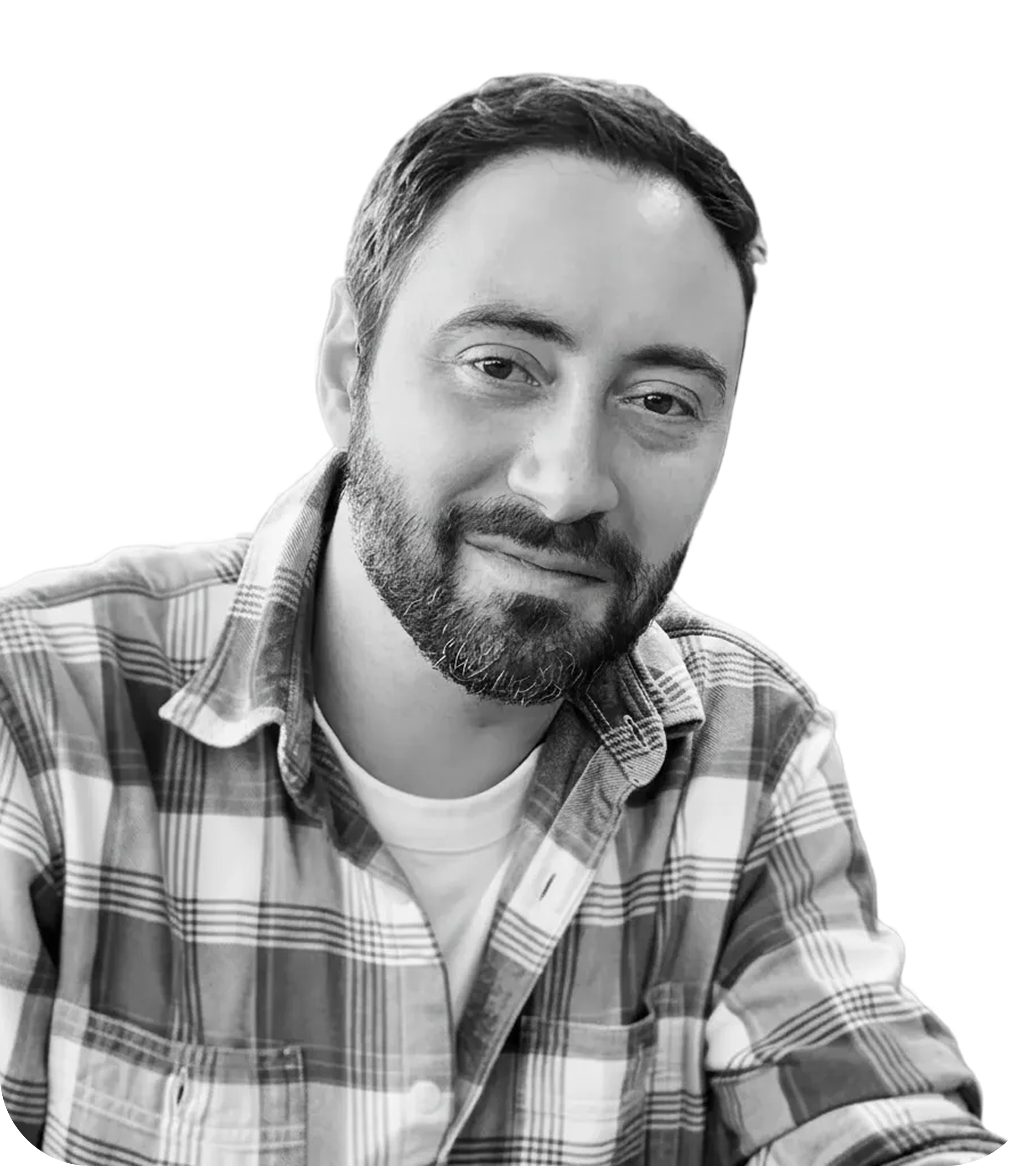 Andrew Gatto, Product and Experience Designer, wearing a green military-style jacket and plaid shirt, smiling warmly with a golden background