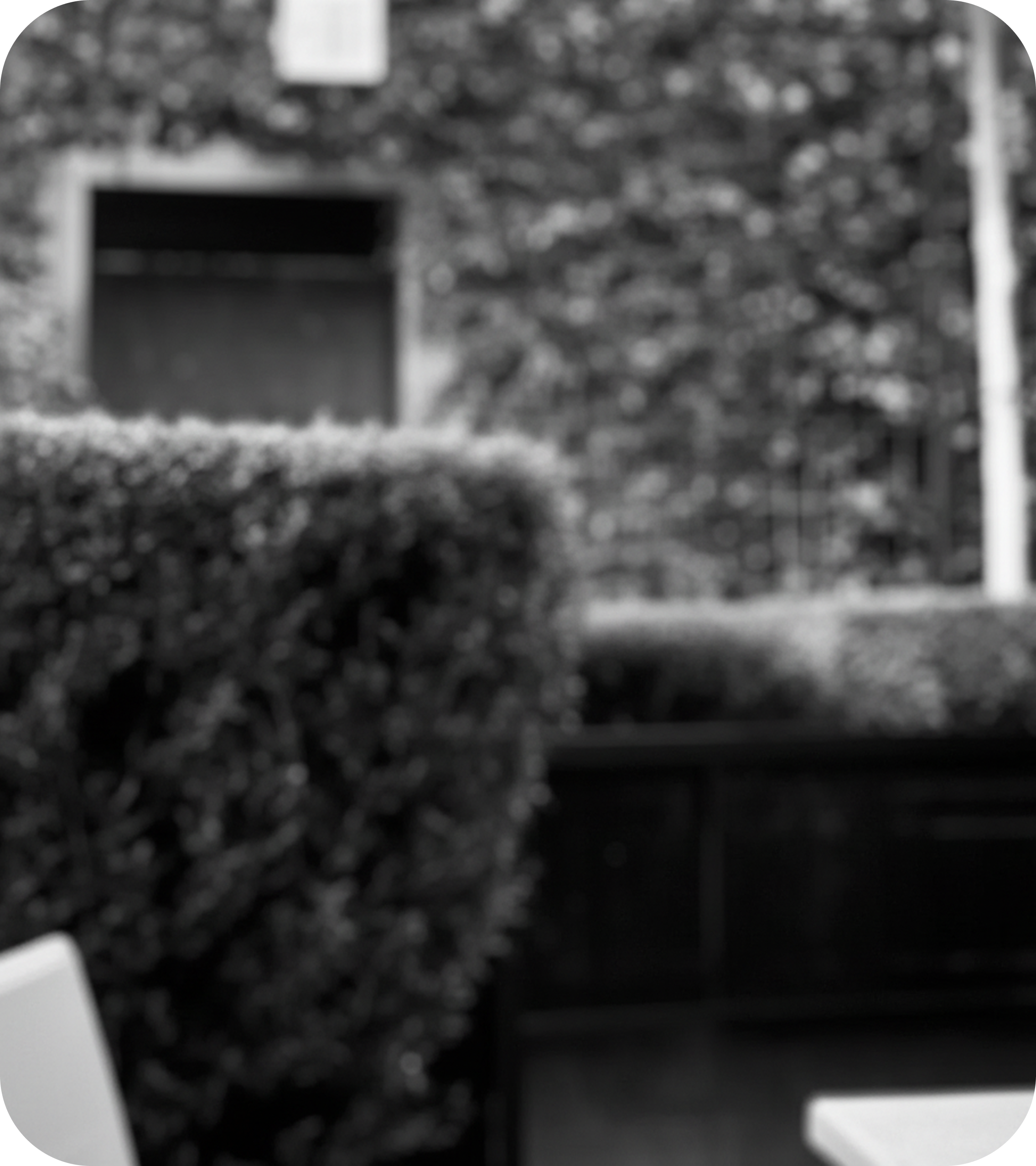 Andrew Gatto, Product and Experience Designer, wearing a green military-style jacket and plaid shirt, smiling warmly with a golden background